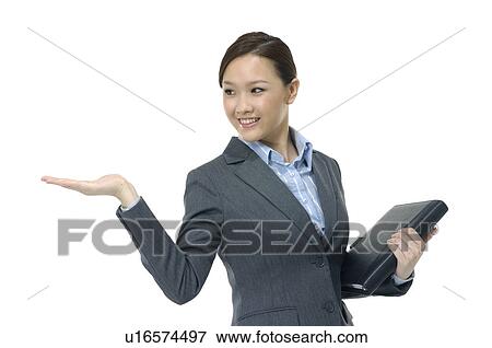 Businesswoman showing her palm and holding a file View Large Photo Image Stock Photo - Businesswoman showing her palm and holding a file. Fotosearch