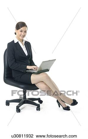 Stock Image - Businesswoman working on a laptop. Fotosearch
