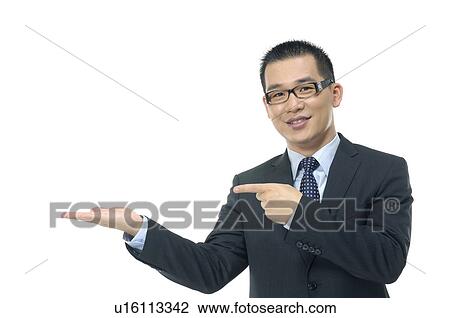 Stock Image - Portrait of a businessman pointing towards his palm. Fotosearch