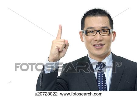 Stock Image - Portrait of a businessman pointing upwards. Fotosearch