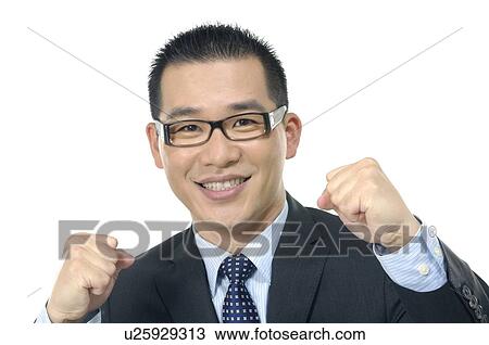 Stock Image - Portrait of a businessman punching in air. Fotosearch