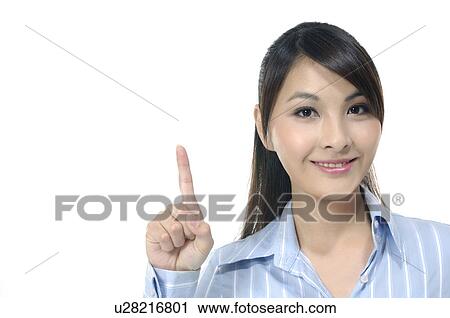 Stock Image - Portrait of a businesswoman pointing upwards. Fotosearch
