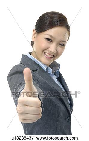 Portrait of a businesswoman showing thumbs up View Large Photo Image Stock Photo - Portrait of a businesswoman showing thumbs up. Fotosearch