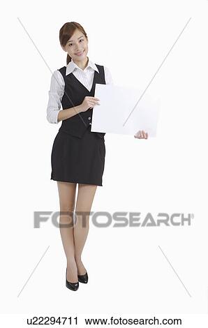 Young businesswoman holding a paper and smiling View Large Photo Image Stock Image - Young businesswoman holding a paper and smiling. Fotosearch