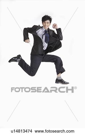 Young man jumping and running with smile View Large Photo Image Picture - Young man jumping and running with smile. Fotosearch