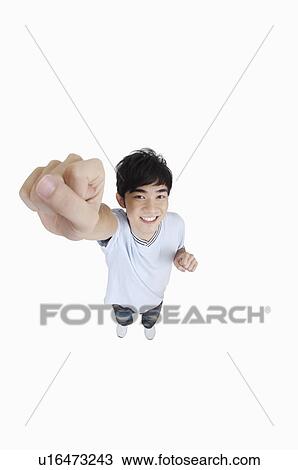 Young man looking up and smiling with fist up View Large Photo Image Stock Image - Young man looking up and smiling with fist up. Fotosearch