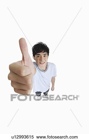 Young man looking up with thumbs up and smiling View Large Photo Image Stock Photography - Young man looking up with thumbs up and smiling. Fotosearch