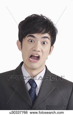 Stock Photograph - Young man making a face with mouth open. Fotosearch