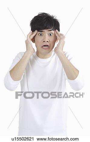 Young man shocking with mouth open and head in hands View Large Photo Image Stock Image - Young man shocking with mouth open and head in hands. Fotosearch