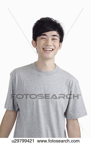 Young man smiling at the camera View Large Photo Image Stock Image - Young man smiling at the camera. Fotosearch