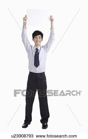 Young man standing with smile and lifting a sign View Large Photo Image Stock Image - Young man standing with smile and lifting a sign. Fotosearch