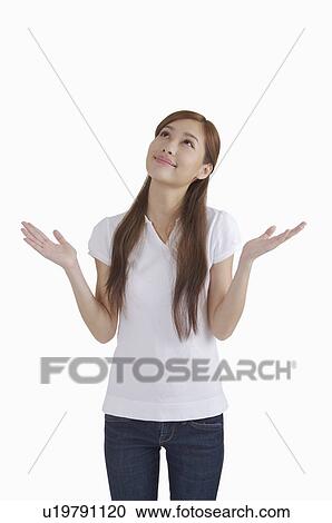 Young woman reaching out hands and looking up with smile View Large Photo Image Stock Image - Young woman reaching out hands and looking up with smile. Fotosearch