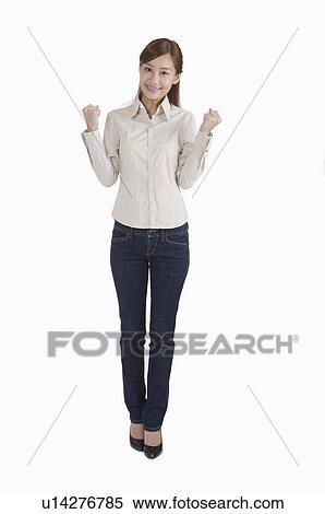 Young woman standing with fists up and smiling View Large Photo Image Stock Photography - Young woman standing with fists up and smiling. Fotosearch