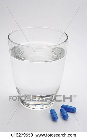 Close-up of a glass of water and pills View Large Photo Image Stock Photo - Close-up of a glass of water and pills. Fotosearch