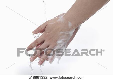 Stock Image - Close-up of human hands washing with soap bubbles. Fotosearch