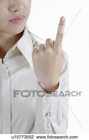 Stock Image - Young man having adhesive bandage on his finger. Fotosearch