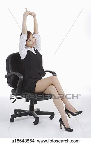 Young Office Lady Sitting On Chair And Stretching Picture