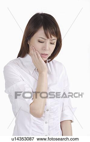 Young woman having toothache and frowning with eyes closed View Large Photo Image Stock Photo - Young woman having toothache and frowning with eyes closed. Fotosearch