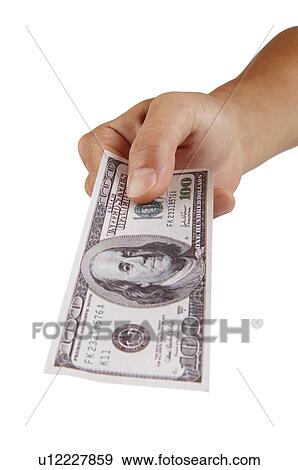 Stock Photo - Human hand giving a US paper currency. Fotosearch