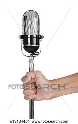 Human hand holding a microphone View Large Photo Image Picture - Human hand holding a microphone. Fotosearch