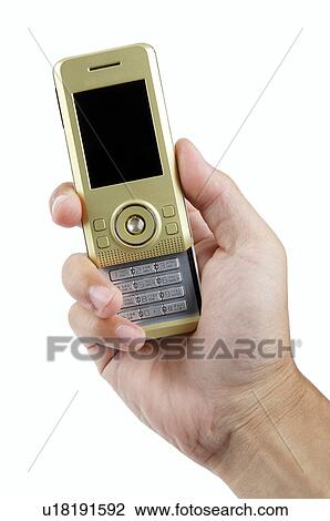 Stock Image - Human hand holding a mobile phone. Fotosearch