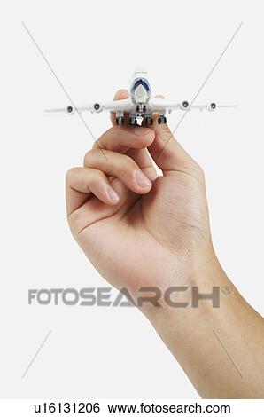 Human hand holding a model airplane View Large Photo Image Stock Photograph - Human hand holding a model airplane. Fotosearch