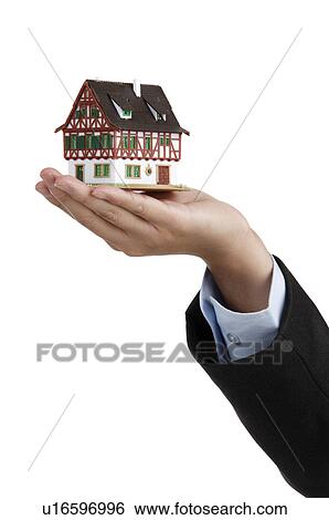 Human hand holding a model house View Large Photo Image Stock Photograph - Human hand holding a model house. Fotosearch