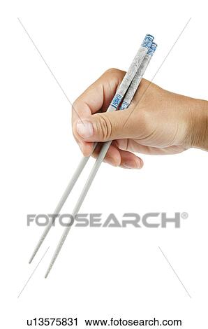 Human hand holding chopsticks View Large Photo Image Stock Image - Human hand holding chopsticks. Fotosearch