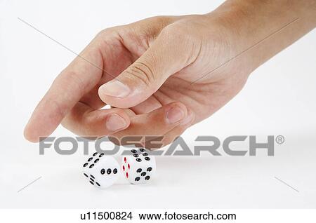 Picture - Human hand playing with dice. Fotosearch