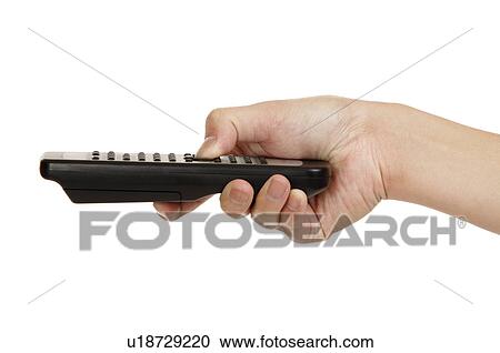Stock Image - Human hand pressing a remote control. Fotosearch