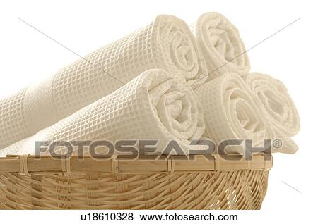Stock Photo - A basket full of white piqué-towels. Fotosearch