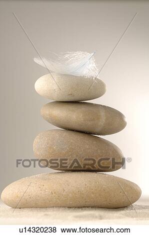 Stock Photo - A stack of stones and a feather. Fotosearch