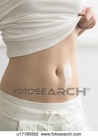 Cream streaks on a belly View Large Photo Image Stock Image - Cream streaks on a belly. Fotosearch