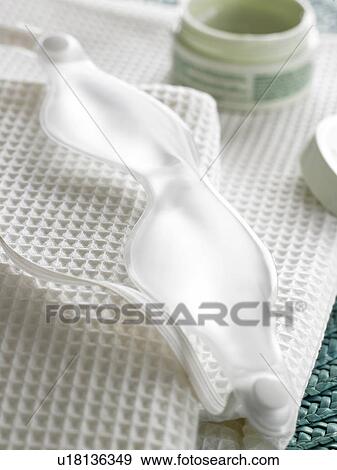 Stock Photo - Eye-screen and cream dish placed on piqué towels. Fotosearch