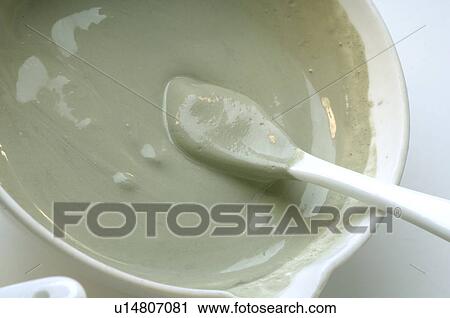 Stock Image - Mixing green clay. Fotosearch