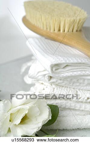 Stock Image - Piqué towels and a massage brush decorated with lisianthus flowers. Fotosearch