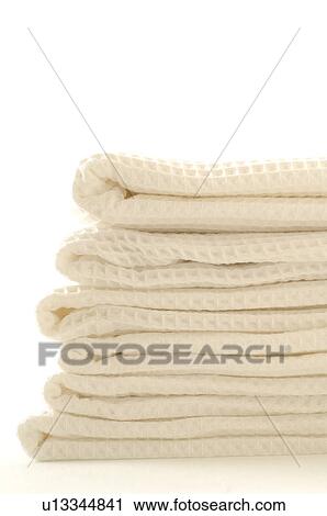 Stock Image - Stack of white piqué towels. Fotosearch