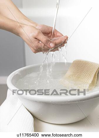 Water is running through hands into a washbowl View Large Photo Image Stock Image - Water is running through hands into a washbowl. Fotosearch