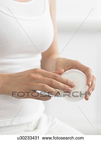 Stock Image - Woman with cream dish. Fotosearch