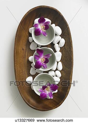 Wooden bowl decorated with pebbles and flowers in porcellain bowls View Large Photo Image Stock Photo - Wooden bowl decorated with pebbles and flowers in porcellain bowls. Fotosearch