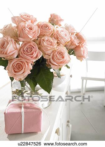 Stock Photograph - Pink bouquets and a wrapped gift. Fotosearch