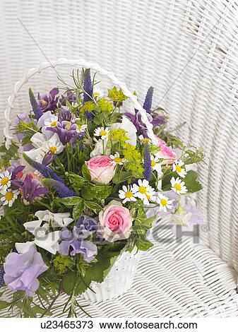 Stock Image - Roses, sweet pea, veronica, camomile and, akelei in a basket. Fotosearch