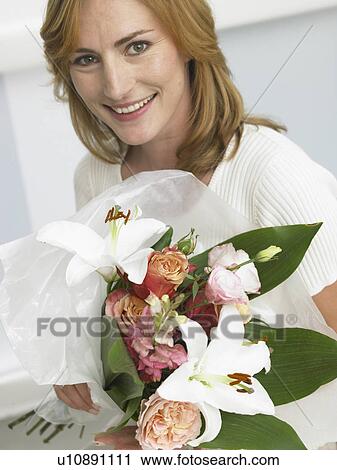 Woman with a bouquet View Large Photo Image Stock Image - Woman with a bouquet. Fotosearch
