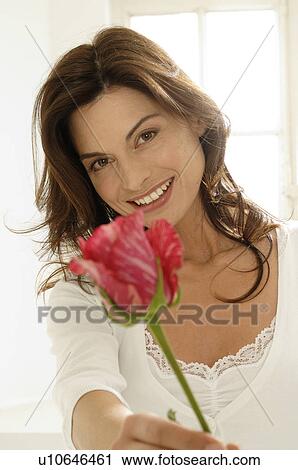 Stock Image - Woman with a rose. Fotosearch