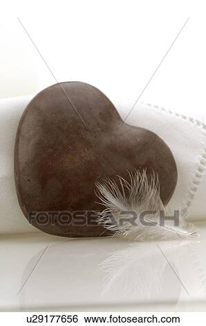 Stock Photograph - Brown heart and a feather. Fotosearch