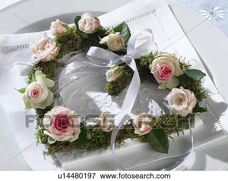 Stock Photo - Heart shape wreath with rose blossoms. Fotosearch