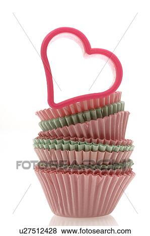 Stock Photo - Muffin paper cups and a hearthshape cookie cutter. Fotosearch