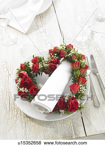 Stock Photo - Napkin and a heartshape wreath of roses. Fotosearch
