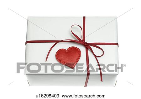 Stock Photo - White wrapped gift with a red heart. Fotosearch