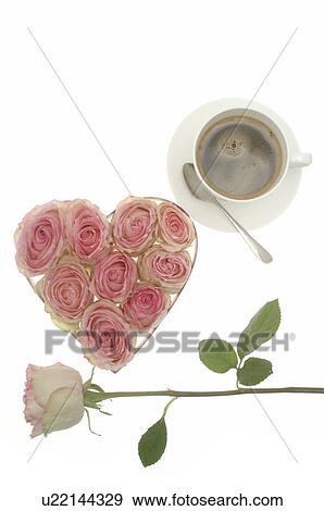 Stock Photo - Heart shape box with rose blossoms, pink rose and a cup of coffee. Fotosearch